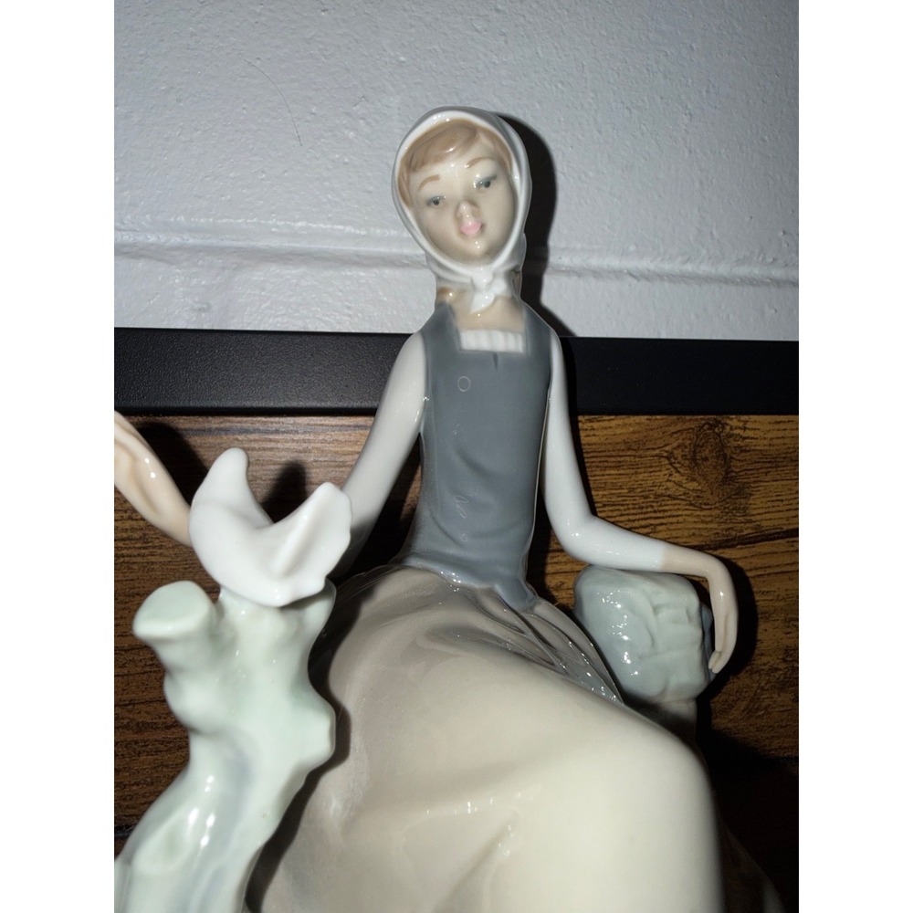 Lladró porcelain sculpture titled "Shepherdess with Dove